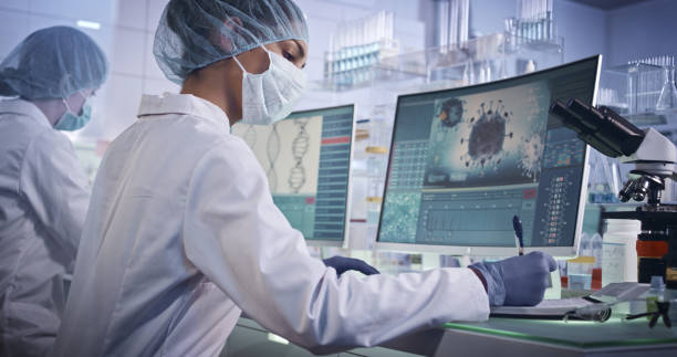 Research and citation regarding Covid information. Young team during coronavirus lab tests. Wearing protective masks and caps